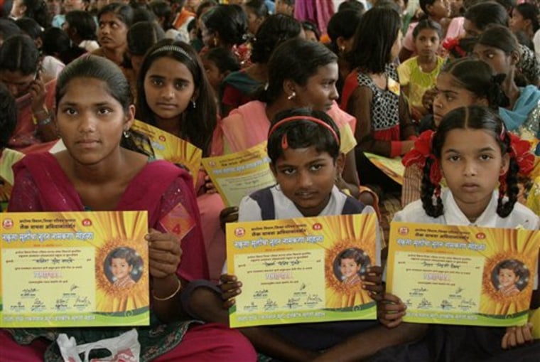 Girls hold certificates stating their new official names during a renaming ceremony in Satara, India, on Saturday. Almost 300 Indian girls known officially as "Unwanted" have traded their birth names for a fresh start in life. 